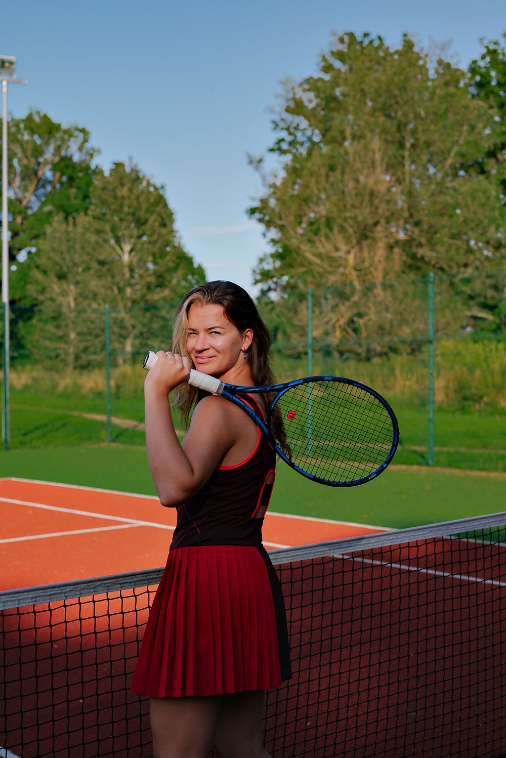 Ilona smiling with her racket over her shoulder