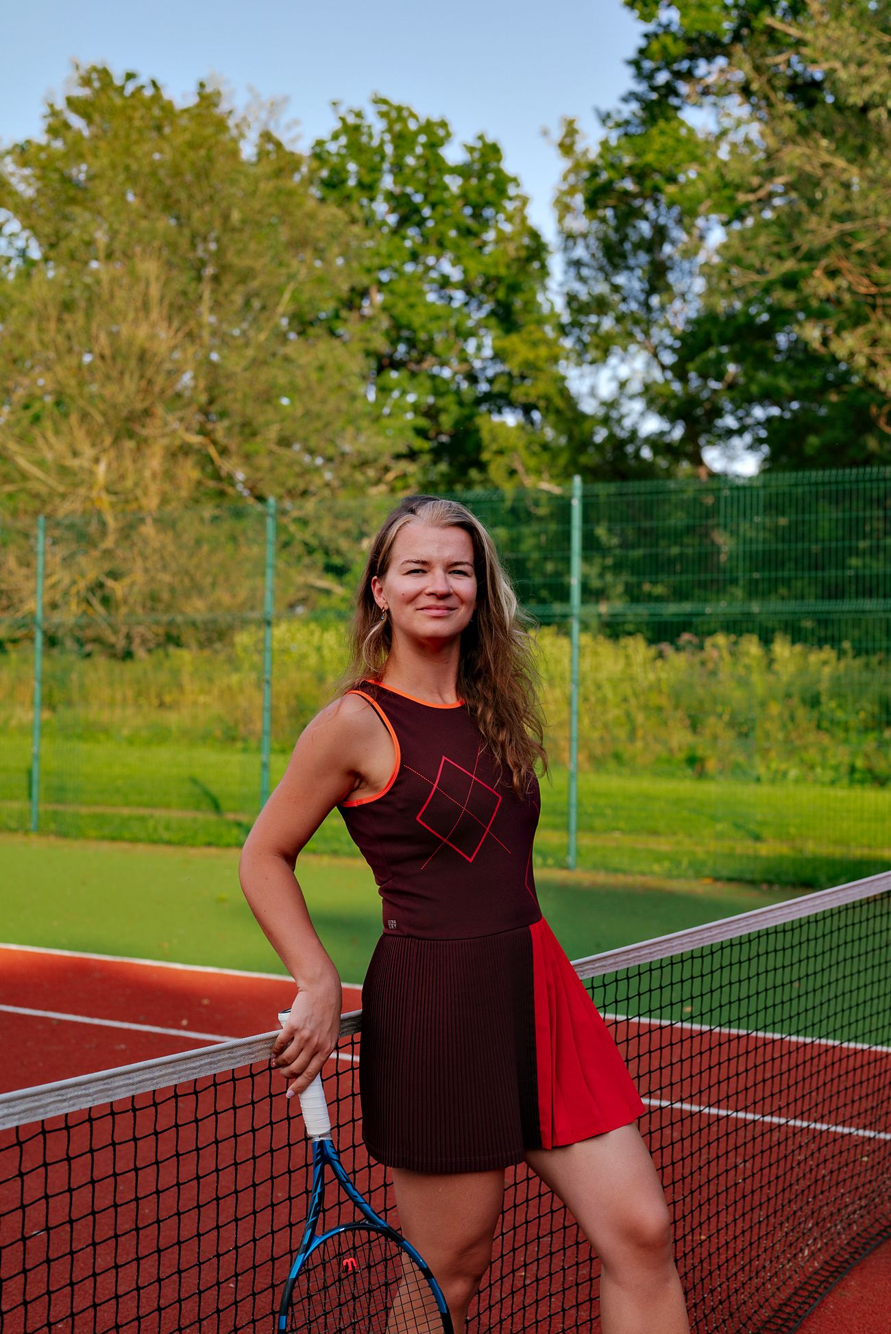 Ilona Schorm smiling at the net with her racket
